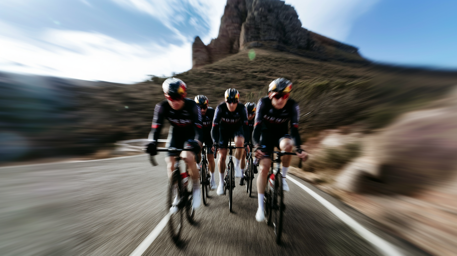 Cycling team riding on a road with a scenic background