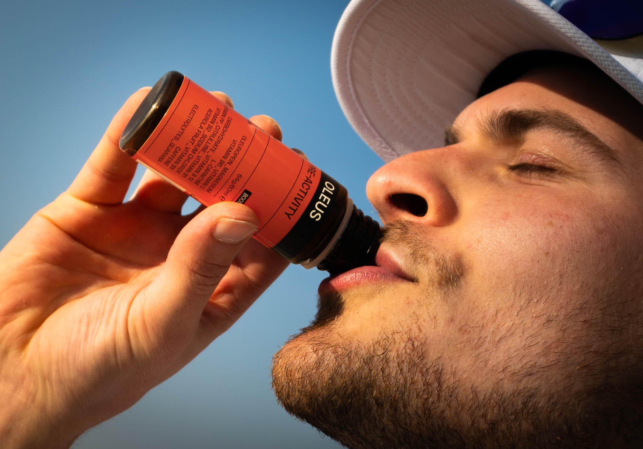 Runner drinking an OLEUS Pre-Activity Shot 30-60 minutes before his intense training